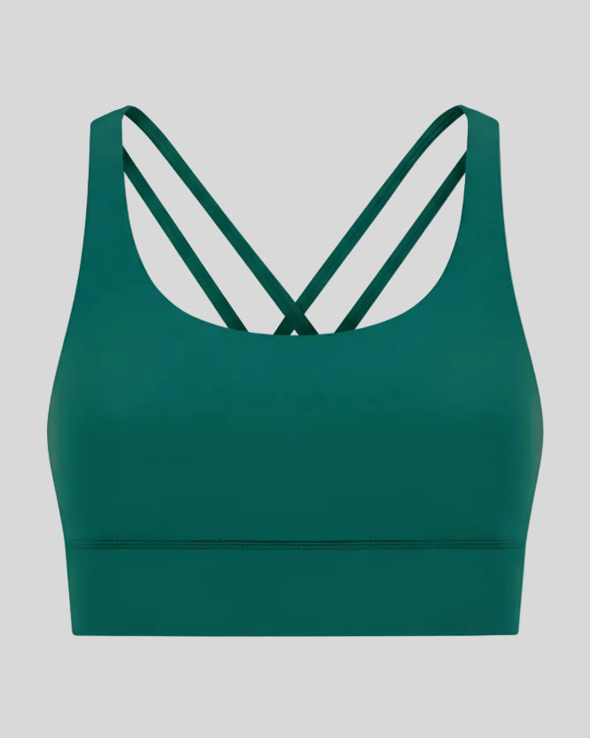 3D product view of the AlignCross Studio Bra in dark green, highlighting the scoop neckline and crisscross back straps.