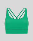 3D product view of the AlignCross Studio Bra in green, highlighting the scoop neckline and crisscross back straps.