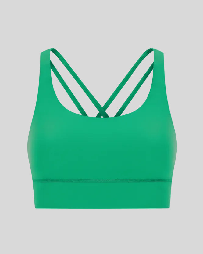 3D product view of the AlignCross Studio Bra in green, highlighting the scoop neckline and crisscross back straps.