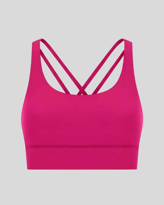 3D product view of the AlignCross Studio Bra in hot pink, highlighting the scoop neckline and crisscross back straps.