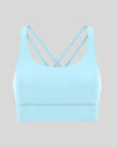 3D product view of the AlignCross Studio Bra in pastel blue, highlighting the scoop neckline and crisscross back straps.