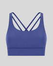 3D product view of the AlignCross Studio Bra in royal blue, highlighting the scoop neckline and crisscross back straps.