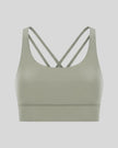 3D product view of the AlignCross Studio Bra in sage, highlighting the scoop neckline and crisscross back straps.