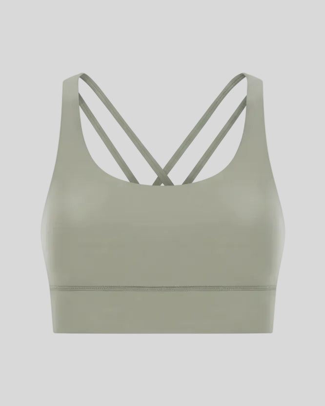 3D product view of the AlignCross Studio Bra in sage, highlighting the scoop neckline and crisscross back straps.