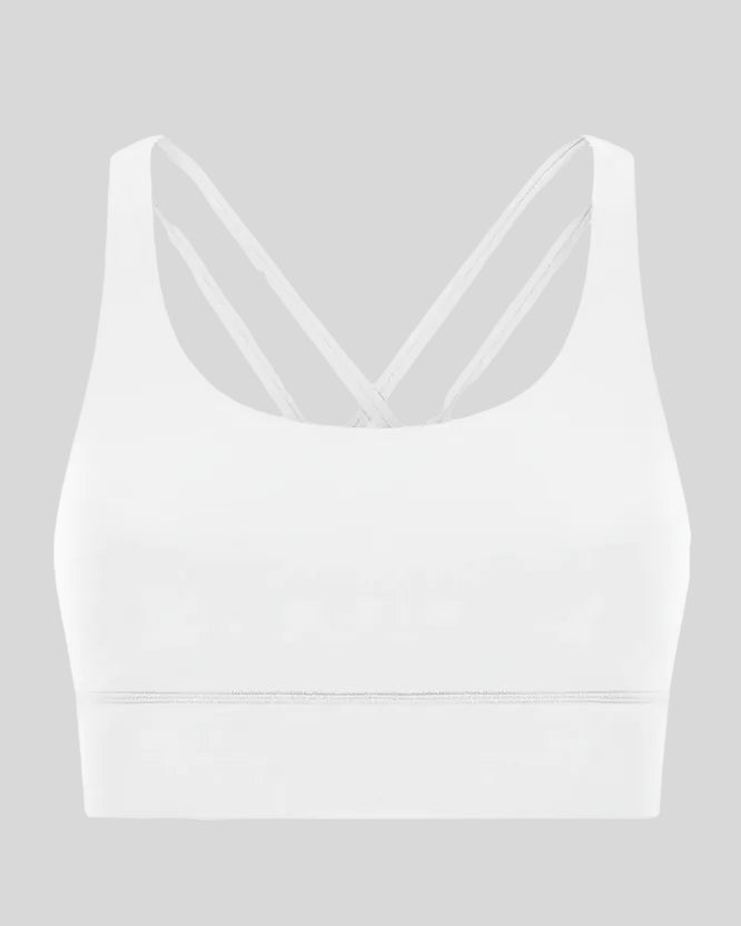 3D product view of the AlignCross Studio Bra in white, highlighting the scoop neckline and crisscross back straps.