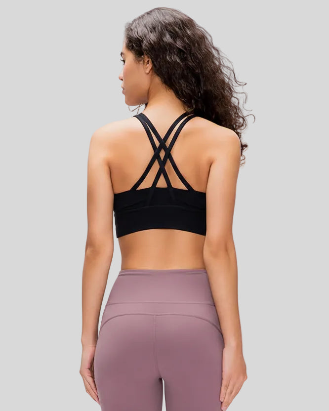 Back view of the AlignCross Studio Bra in black, highlighting the crisscross strap design.