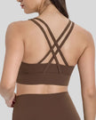 Back view of the AlignCross Studio Bra in brown, highlighting the crisscross strap design.