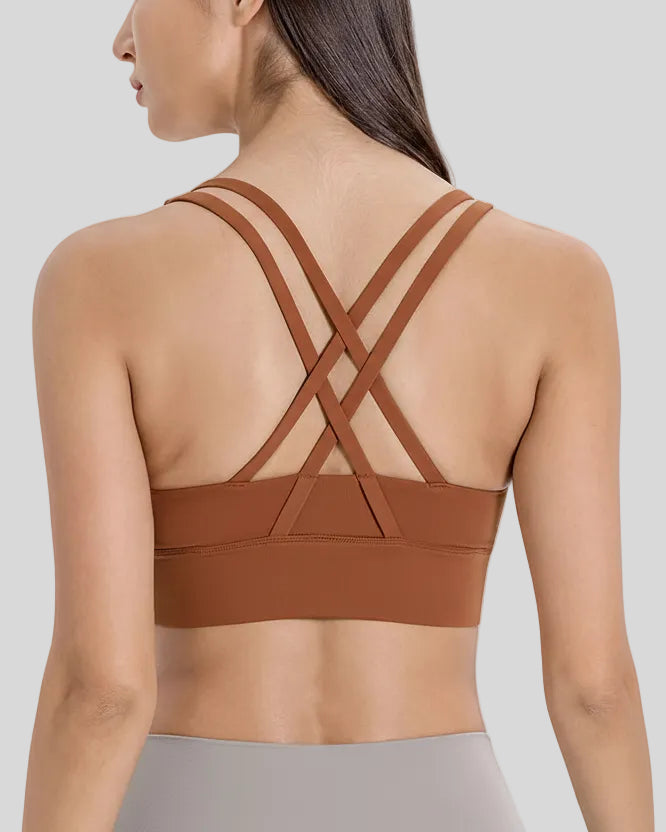 Back view of the AlignCross Studio Bra in caramel brown, highlighting the crisscross strap design.