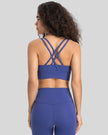 Back view of the AlignCross Studio Bra in royal blue, highlighting the crisscross strap design.