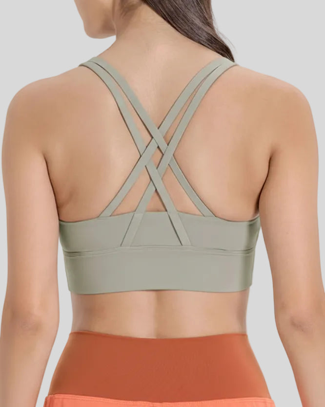 Back view of the AlignCross Studio Bra in sage, highlighting the crisscross strap design.