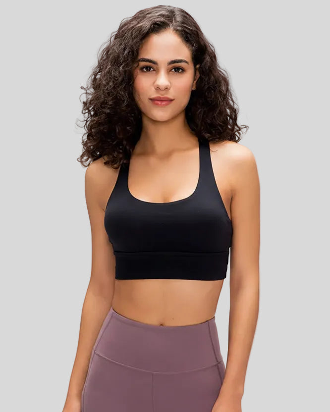 AlignCross Studio Bra in black worn by model, featuring a scoop neckline and soft supportive fit.