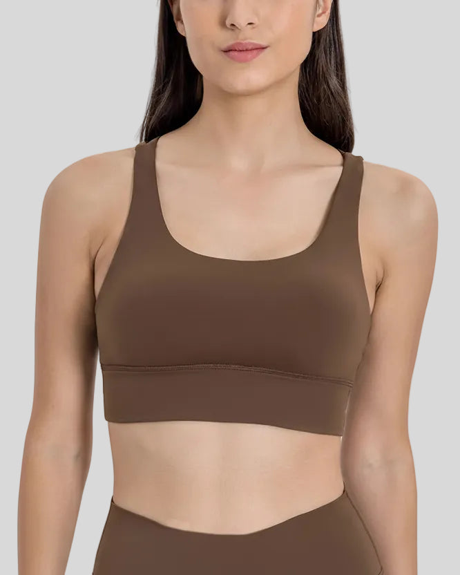 AlignCross Studio Bra in brown worn by model, featuring a scoop neckline and soft supportive fit.