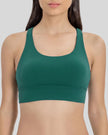 AlignCross Studio Bra in dark green worn by model, featuring a scoop neckline and soft supportive fit.