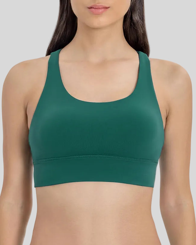 AlignCross Studio Bra in dark green worn by model, featuring a scoop neckline and soft supportive fit.