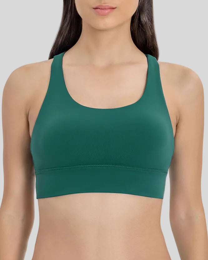AlignCross Studio Bra in dark green worn by model, featuring a scoop neckline and soft supportive fit.