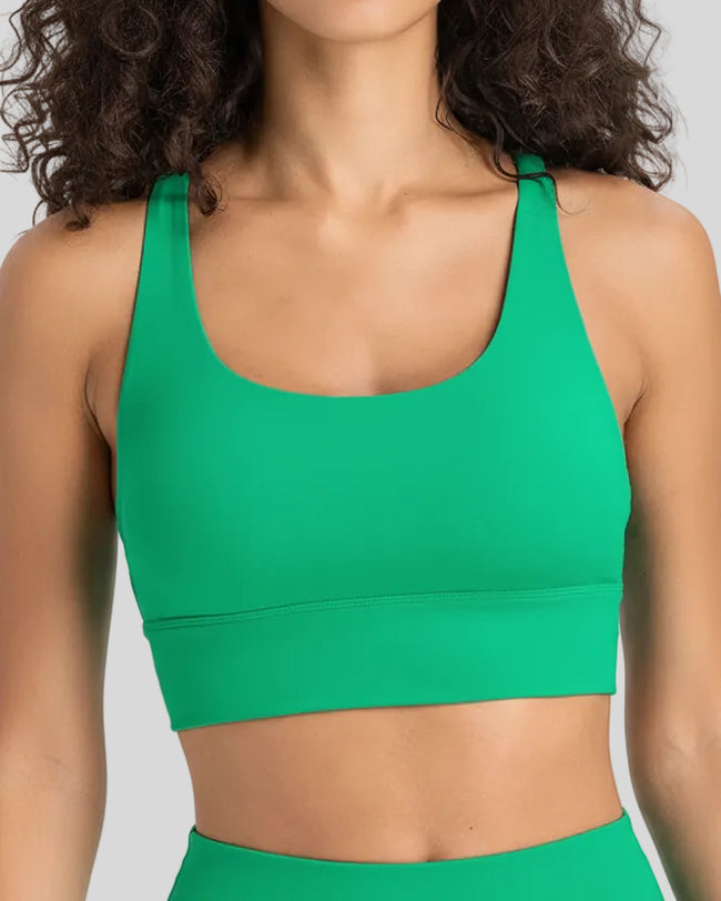 AlignCross Studio Bra in green worn by model, featuring a scoop neckline and soft supportive fit.