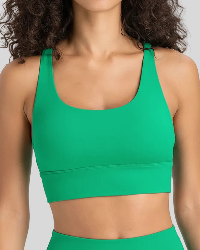 AlignCross Studio Bra in green worn by model, featuring a scoop neckline and soft supportive fit.