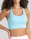 AlignCross Studio Bra in pastel blue worn by model, featuring a scoop neckline and soft supportive fit.