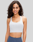 AlignCross Studio Bra in white worn by model, featuring a scoop neckline and soft supportive fit.