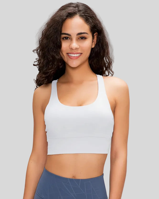 AlignCross Studio Bra in white worn by model, featuring a scoop neckline and soft supportive fit.
