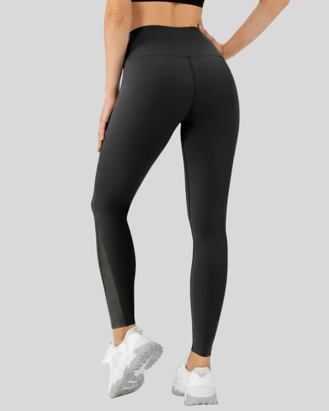 Back angle view of AeroFlow mesh legging in black with smooth sculpted fit