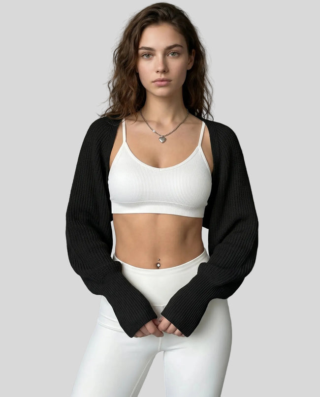 Front view of AirLoom Knit Shrug in black layered over neutral activewear