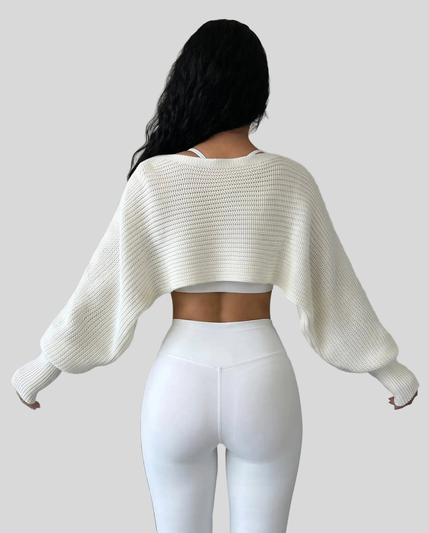 Back view of AirLoom Knit Shrug in white with oversized sleeves and cropped silhouette