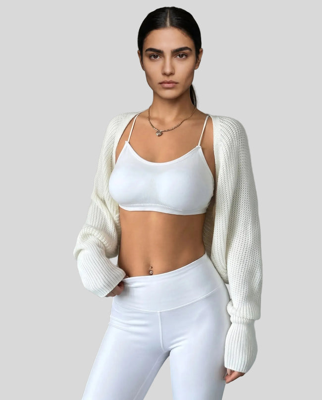 Front view of AirLoom Knit Shrug in white layered over neutral activewear