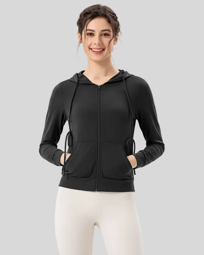 Woman wearing a black airshield zip hoodie with closed zipper on a light gray background