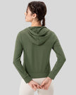 Back view of matcha green relaxed-fit active hoodie showing hood and fabric