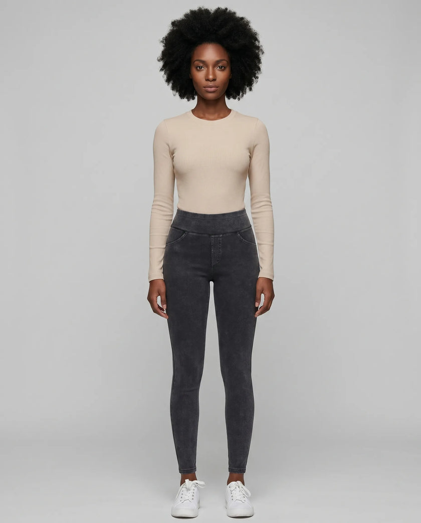 Athlesi AlignForm leggings charcoal color styled on model with activewear top in minimal setting