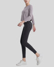 Model wearing Athlesi AlignForm leggings in charcoal color side view showing contouring fit and seamless design