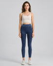 Athlesi AlignForm leggings dark color styled on model with activewear top in minimal setting