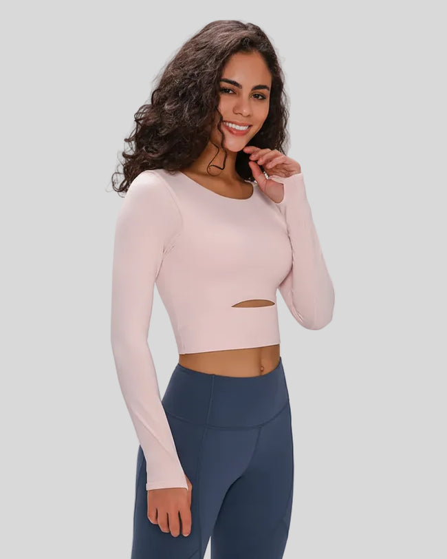 Angled front view of Athlesi AlignLift Studio long sleeve top in blush pink