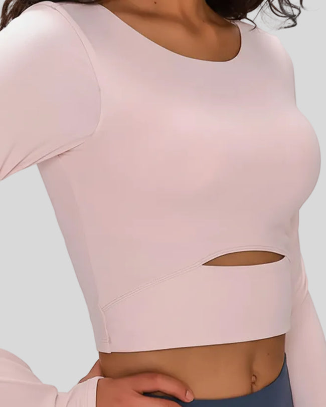 Close-up of Athlesi AlignLift Studio long sleeve top fabric and cutout detail in blush pink