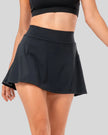 Pleated active skirt in black shown from front right angle with athletic, feminine silhouette