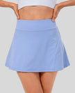 Closeup of high-rise pleated active skirt in light blue with smooth waistband and lightweight performance fabric
