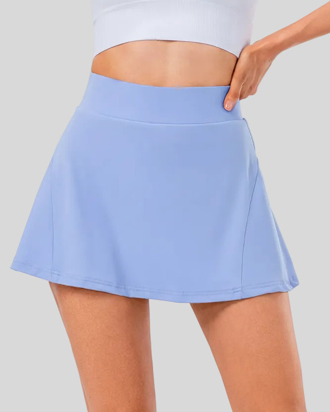 Front angle view of high-rise pleated active skirt in light blue with smooth waistband and lightweight performance fabric