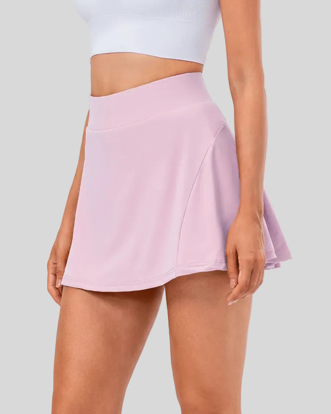 Side view of pleated active skirt in pink purple highlighting lightweight drape and athletic fit