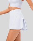 Side view of pleated active skirt in white highlighting lightweight drape and athletic fit