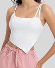 Angled view of AsymFlow Edge Active Cami in white, showing asymmetrical cut and soft stretch fabric
