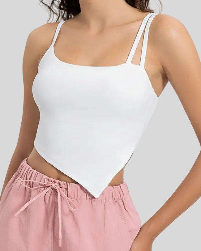 Angled view of AsymFlow Edge Active Cami in white, showing asymmetrical cut and soft stretch fabric