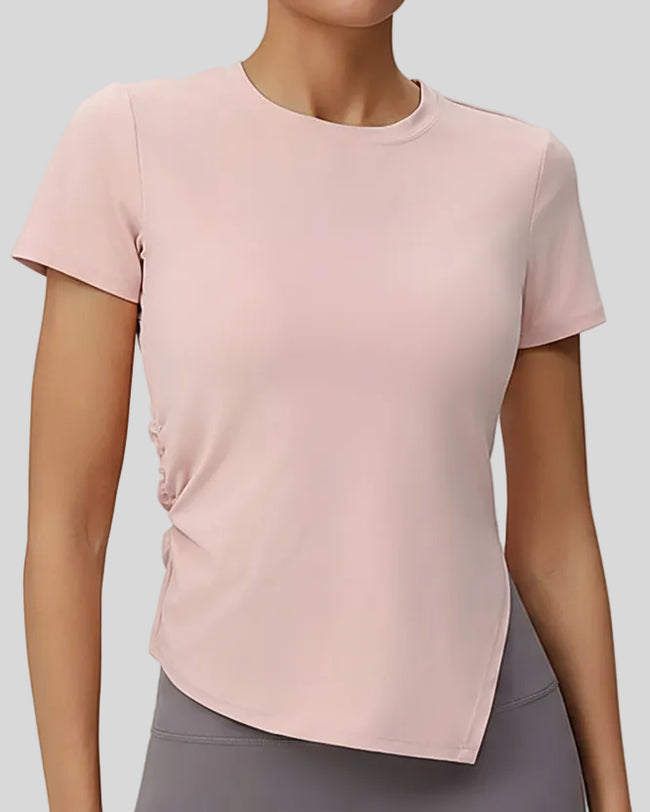 AsymFlow short sleeve active top in peach powder with relaxed fit and round neckline