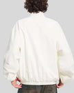 Upper body back view of man wearing Axis Bomber Jacket in Beige