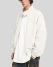 Upper body side angle view of man wearing Axis Bomber Jacket in Beige