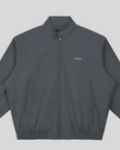 Closeup of stand collar, Athlesi logo, button detail and front zipper on Axis Bomber Jacket in Dark Gray