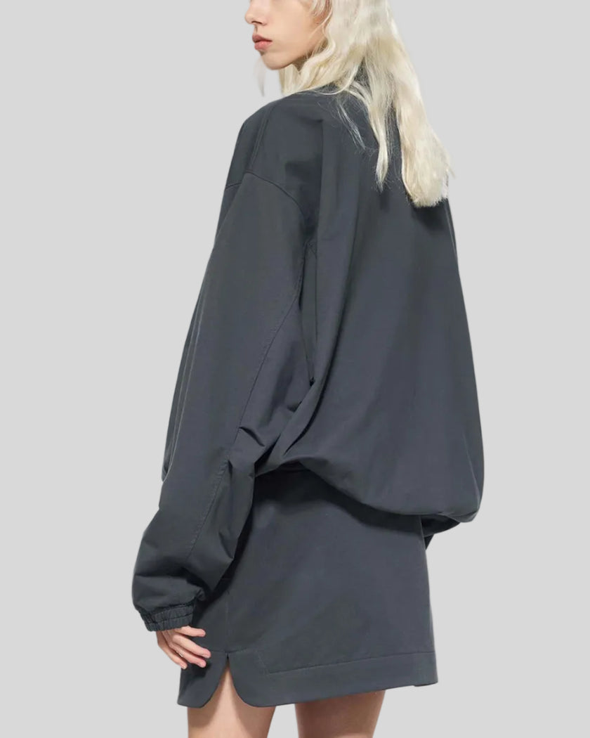 Mid body back angle view of woman wearing Axis Bomber Jacket in Dark Gray