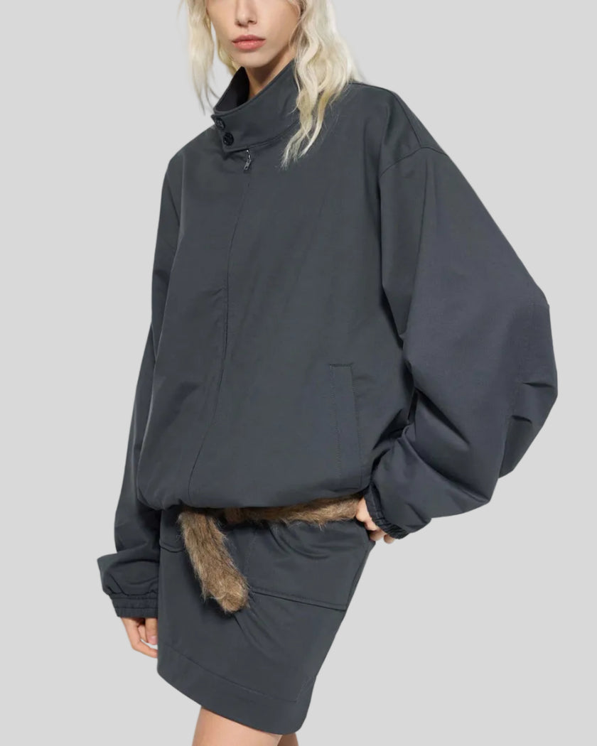 Mid body front angle view of woman wearing Axis Bomber Jacket in Dark Gray