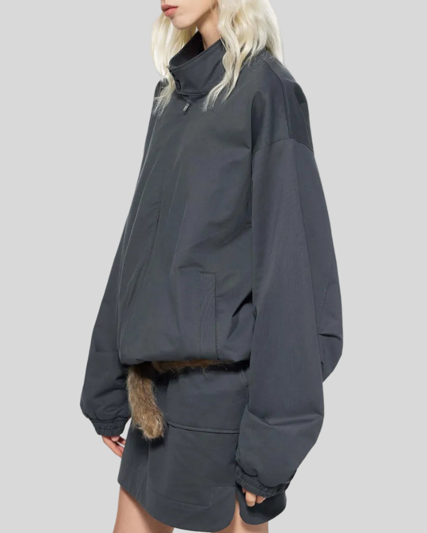 Mid body side view of woman wearing Axis Bomber Jacket in Dark Gray