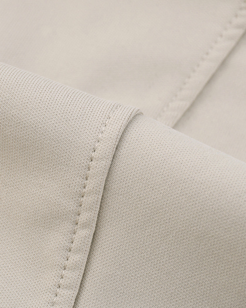 Closeup of smooth cotton-blend performance fabric on Axis Bomber Jacket in Gray Camel